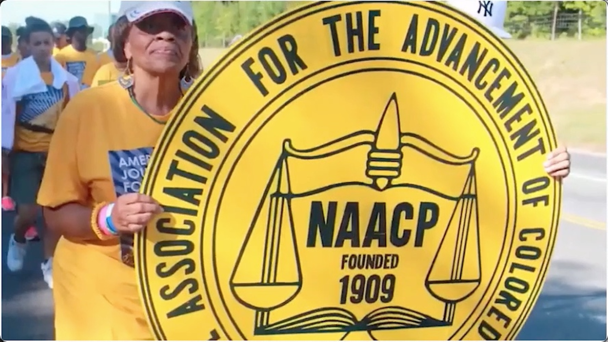 Woman holding up NAACP Sign
